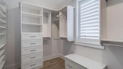 a white closet with white drawers and a window at Azzurro Moon in Seagrove Beach