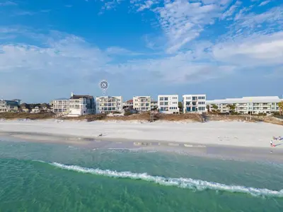 a view of a beach with buildings in the background at Azzurro Moon in Seagrove Beach