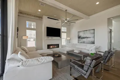 a living room with white furniture and a fireplace at Gulf Shore Manor in Santa Rosa Beach