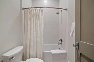 a white bathroom with a toilet and a shower at Gulf Shore Manor in Santa Rosa Beach