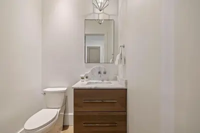 a bathroom with a toilet and a sink and a mirror at Gulf Shore Manor in Santa Rosa Beach