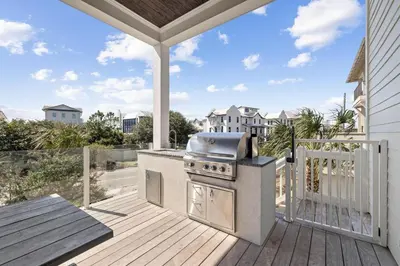 a outdoor kitchen with a grill on a deck at Gulf Shore Manor in Santa Rosa Beach