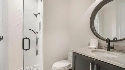 a bathroom with a toilet and a sink and a mirror at Azzurro Dream in Seagrove Beach