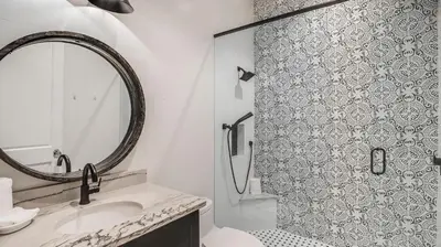 a bathroom with a shower and a sink and a mirror at Azzurro Dream in Seagrove Beach