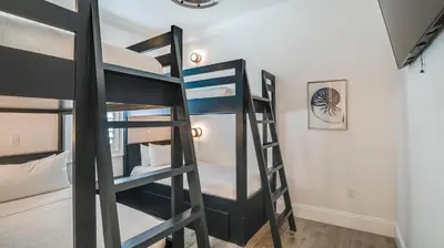 a bunk bed room with three bunk beds in a room at Azzurro Dream in Seagrove Beach