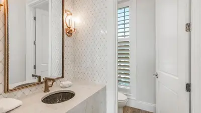 a bathroom with a sink and a mirror at Azzurro Dream in Seagrove Beach