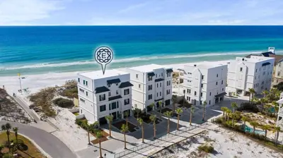 an aerial view of a building next to the beach at Azzurro Dream in Seagrove Beach