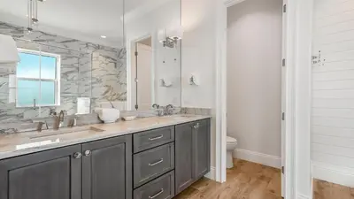 a bathroom with a sink and a large mirror at Azzurro Dream in Seagrove Beach