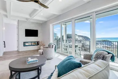 a living room with a view of the ocean at Azzurro Sky in Seagrove Beach