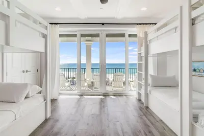 a bedroom with a bed and a view of the ocean at Azzurro Sky in Seagrove Beach