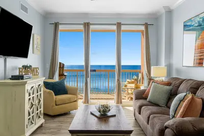 a living room with a couch and a large window at 1002 Sunrise Beach in Panama City Beach