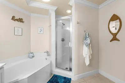 a bathroom with a shower and a bath tub at 1002 Sunrise Beach in Panama City Beach