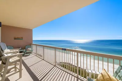 a balcony with chairs and a view of the ocean at 1002 Sunrise Beach in Panama City Beach