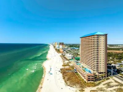 a view of a beach with a building and the ocean at 1002 Sunrise Beach in Panama City Beach