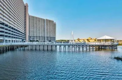 a pier in the water next to a large building at Panama City -3 Bedroom - Laketown Wharf in Panama City Beach