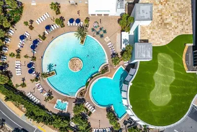 an overhead view of a pool with chaise lounge chairs at Panama City -3 Bedroom - Laketown Wharf in Panama City Beach