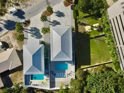an overhead view of a white building with a pool at Majestic View Beach House in Panama City Beach