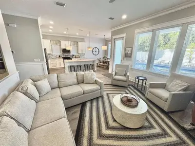 a living room with a couch and a table at Majestic View Beach House in Panama City Beach