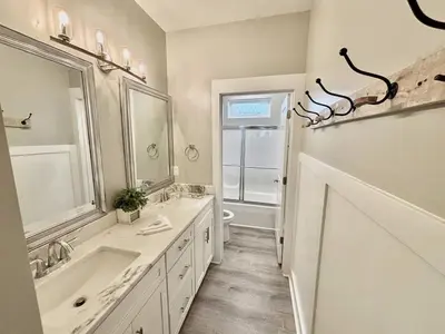 a bathroom with two sinks and a tub and a toilet at Majestic View Beach House in Panama City Beach