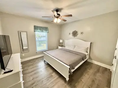 a bedroom with a bed and a ceiling fan at Majestic View Beach House in Panama City Beach
