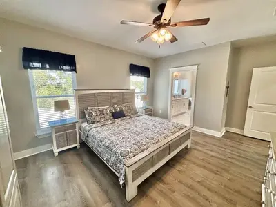 a bedroom with a bed and a ceiling fan at Majestic View Beach House in Panama City Beach