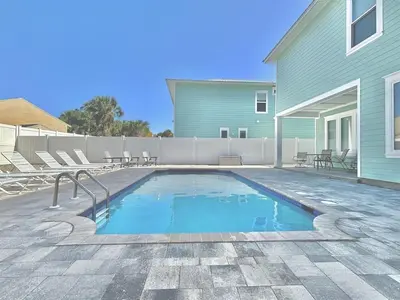 a swimming pool in front of a house at Majestic View Beach House in Panama City Beach