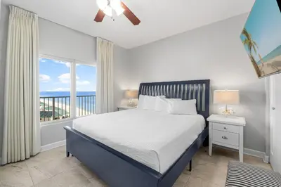 a bedroom with a bed with a view of the ocean at Shores Of Panama #1826 in Panama City Beach