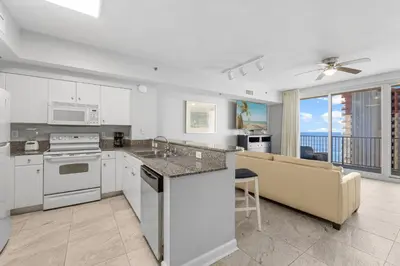 a kitchen and living room with a couch and a table at Shores Of Panama #1826 in Panama City Beach
