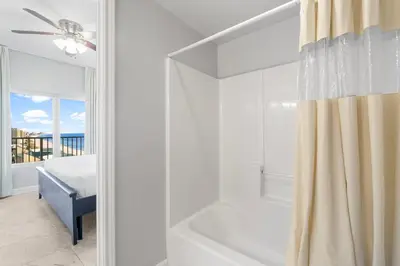a white bathroom with a tub and a shower at Shores Of Panama #1826 in Panama City Beach