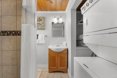 a white bathroom with a sink and a stove at Island Time Bungalow in Panama City Beach