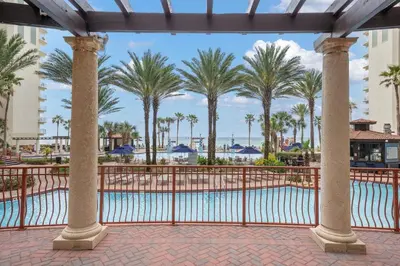 a view of the pool at the resort with palm trees at Shores Of Panama #1930 in Panama City Beach