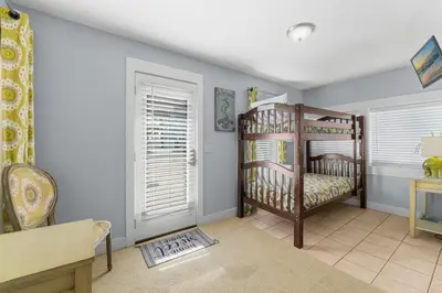 a room with two bunk beds and a window at Salt Life Bungalow in Panama City Beach