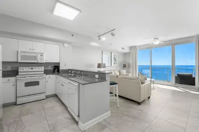 a kitchen and living room with a view of the ocean at Shores Of Panama #1830 in Panama City Beach