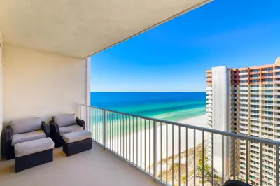 a balcony with chairs and a view of the beach at Shores Of Panama #1926 in Panama City Beach