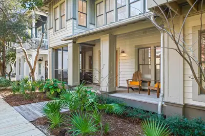 a front porch of a house with plants at Captain Jack Cottage in Rosemary Beach