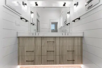 a bathroom with two sinks and a large mirror at Chloe's Cottage and Carriage House in Rosemary Beach