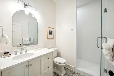 a bathroom with a sink and a toilet and a shower at Rose Cottage in Rosemary Beach