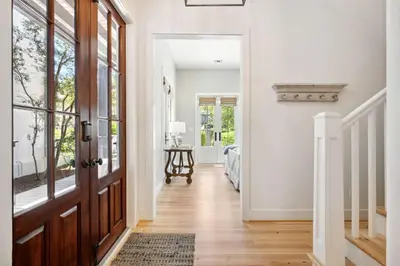 a hallway with a door leading to a bedroom at Rose Cottage in Rosemary Beach