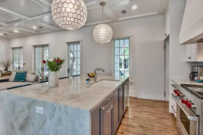 a kitchen with a large island in the middle at Julia's Cottage in Rosemary Beach