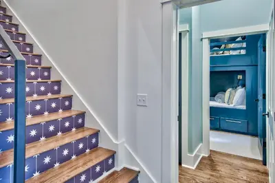 a staircase in a house with blue and white walls at Julia's Cottage in Rosemary Beach