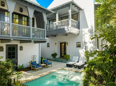 an exterior view of a house with a swimming pool at Abaco Pearl Cottage in Rosemary Beach