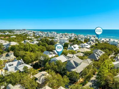 an aerial view of a residential neighborhood with two google signs at Abaco Pearl Carriage House in Rosemary Beach