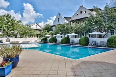 a swimming pool in front of a house at Abaco Pearl Carriage House in Rosemary Beach