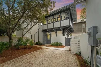 a house with a balcony on the side of it at Julia's Carriage House in Rosemary Beach