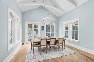 a dining room with a table and chairs at Chalet by the Sea in Santa Rosa Beach