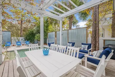 a white table and chairs on a patio at Chalet by the Sea in Santa Rosa Beach