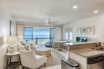 a kitchen and living room with a view of the ocean at Seamist #8 in Seacrest