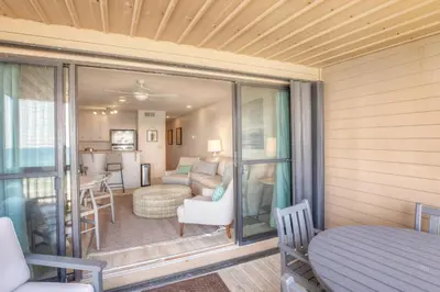 a room with a balcony with a living room at Seamist #8 in Seacrest