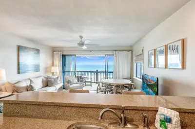 a kitchen and living room with a view of the ocean at Seamist #8 in Seacrest