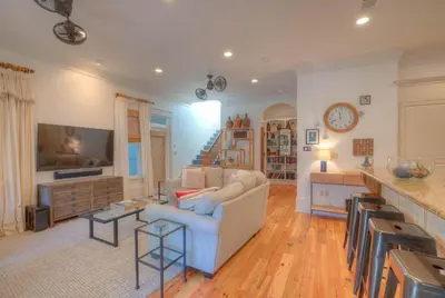a living room with a couch and a tv at Out of Bounds in Santa Rosa Beach